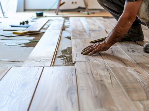 man installing new hardwood flooring